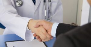 a patient and doctor shake hands after discussing gout treatments