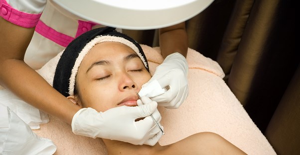 a woman undergoes one of several professional acne treatments