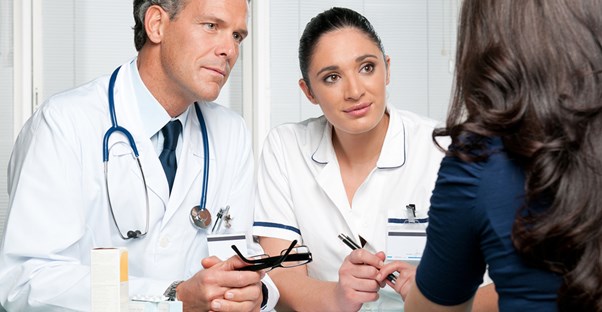 a woman speaks with a doctor and nurse about an iud